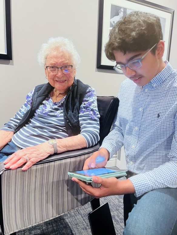 Volunteer helping a senior with technology